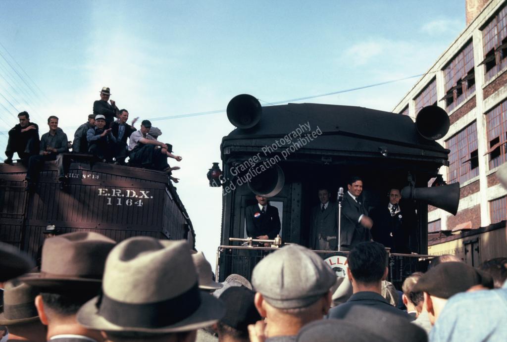Photo of men standing around a train car